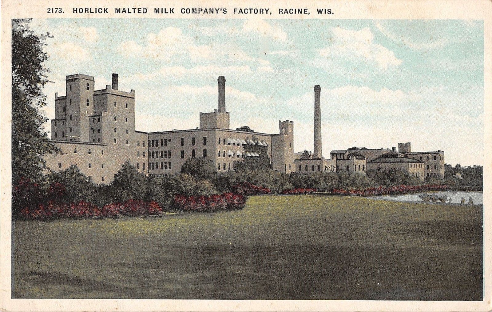 A colored photographic postcard of the Horlick factory building.
