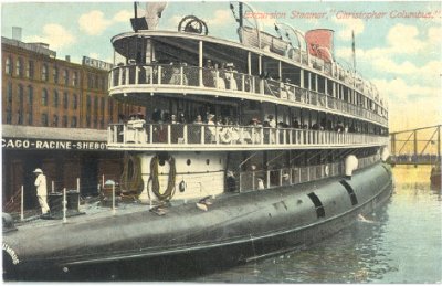A postcard of the SS Christopher Columbus, a whaleback passenger ship, people fill the passenger decks.