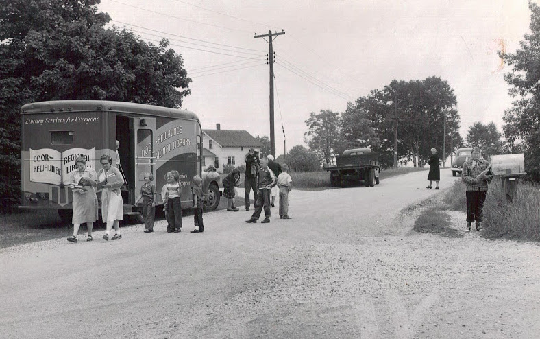 Children wait in line to borrow books from the Door County bookmobile. Image courtesy of the Egg Harbor Historical Society.