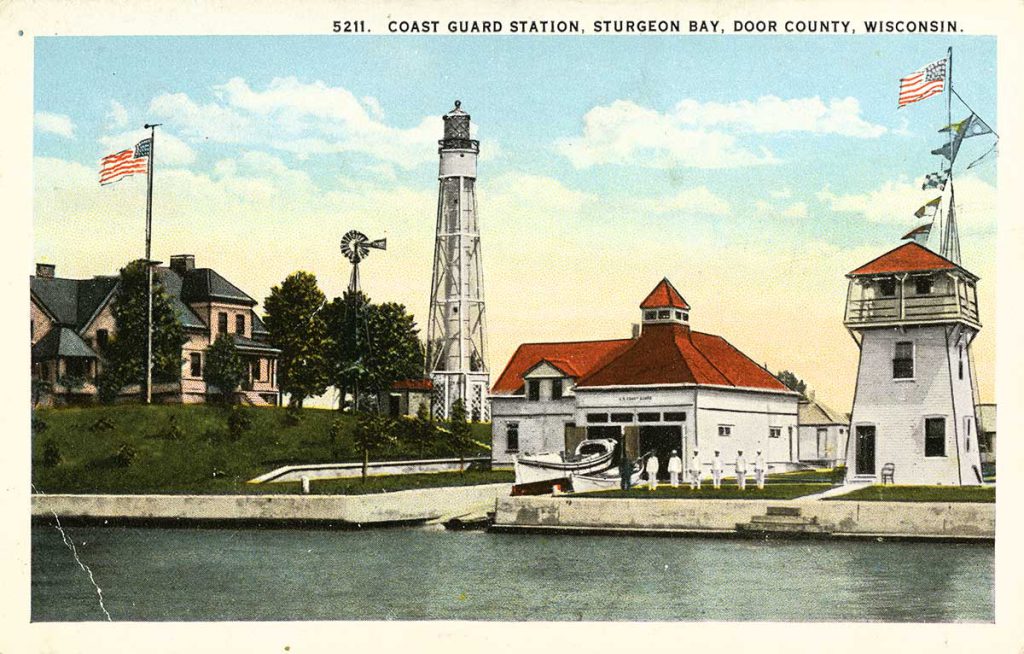 A color postcard showing a lighthouse and lifesaving station in Door County Wisconsin.