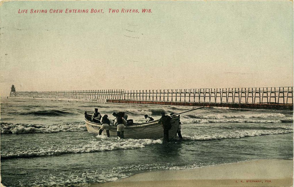 An image of a lifesaving crew pushing a row boat out onto the lake beside a pier.