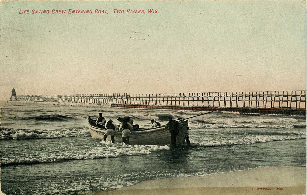 An image of a lifesaving crew pushing a row boat out onto the lake beside a pier.