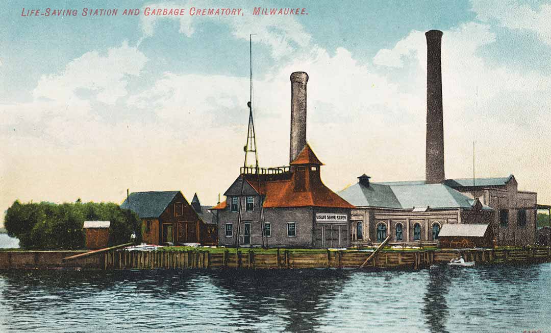 color postcard of an early lifesaving station showing an antennae, towers and houses