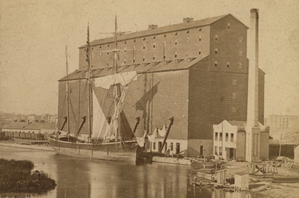 An image of what is believed to be the Tanner before a grain elevator on the lake.
