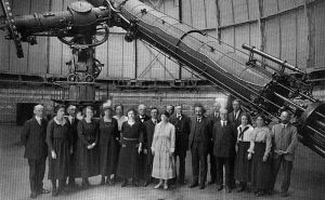 A group portrait inside the Yerkes Observatory featuring Albert Einstein and members of the observatory staff, including several women.
