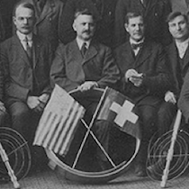 a group of dairymen pose with an american and a swiss flag