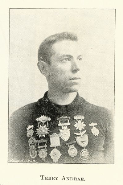 a young man with many bike racing medals pinned to his chest