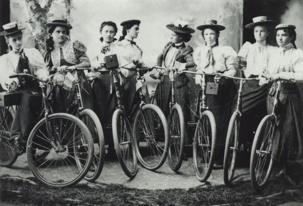 A group of women posing with bicycles