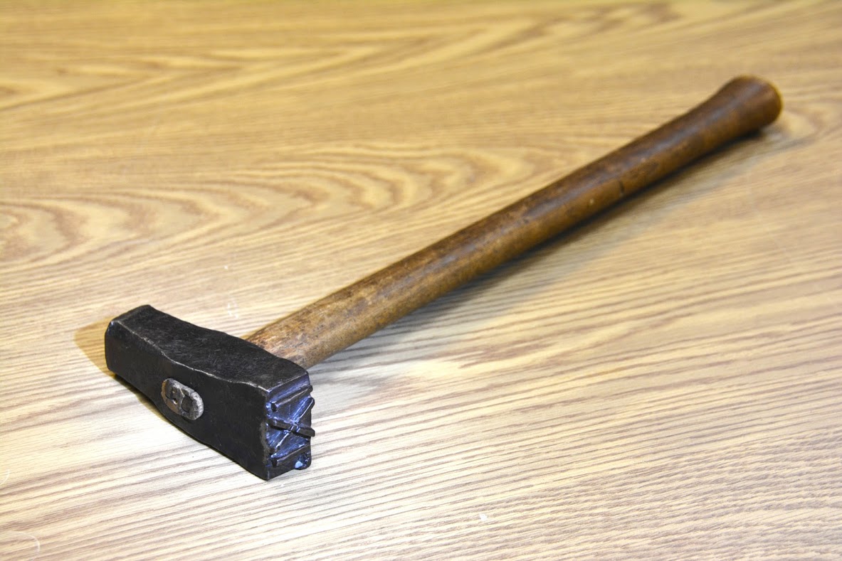 An image of a log marking hammer