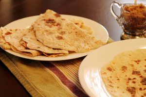 Cooked lefse on plates ready to be eaten!