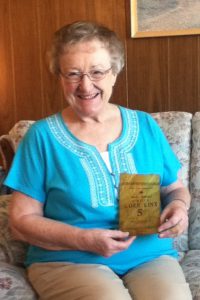 Shirley Beardsley displaying a 5-cent bag of Corn Kinx sold by the Reed family. 