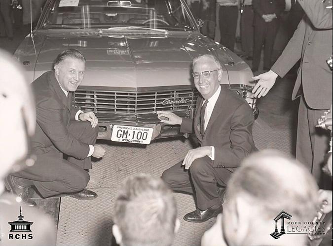 Wisconsin Lieutenant Governor Jack B. Olson and GM President Jack Roche pose as they affix the license plate to the 100,000,000 vehicle. Photograph from the Rock County Historical Society.