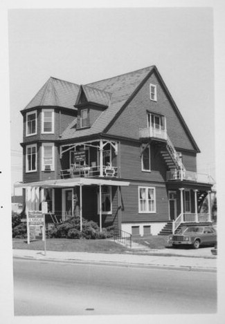Black-and-white photograph of a two-and-a-half story Victorian house.
