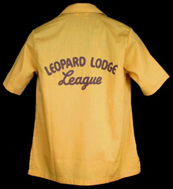 Back of the yellow bowling shirt costume from "Happy Days" with printed brown lettering that reads "Leopard Lodge League"