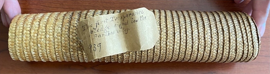 A woven straw document case.