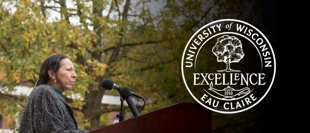 A composite image of a woman standing at a microphone and the seal of the University of Wisconsin-Eau Claire which features an image of the Council Oak over the school’s motto “Excellence.”