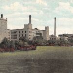 A colored photographic postcard of the Horlick factory building.