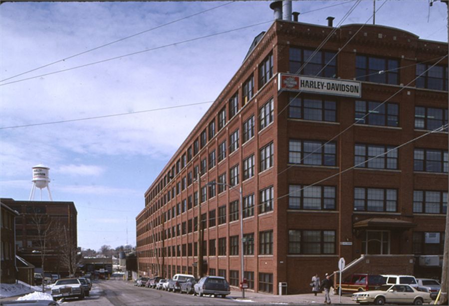 Photograph of the first Harley-Davidson factory, a five-story brick factory building.