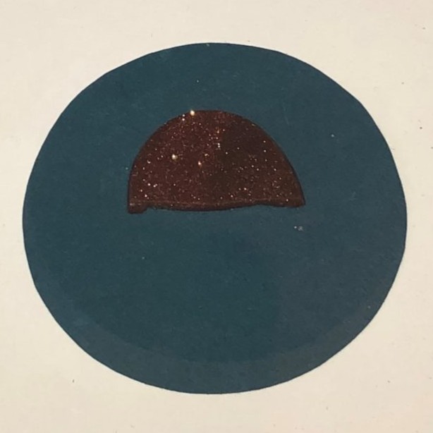 Burned fragment of a breast pin.