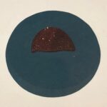 Burned fragment of a breast pin.