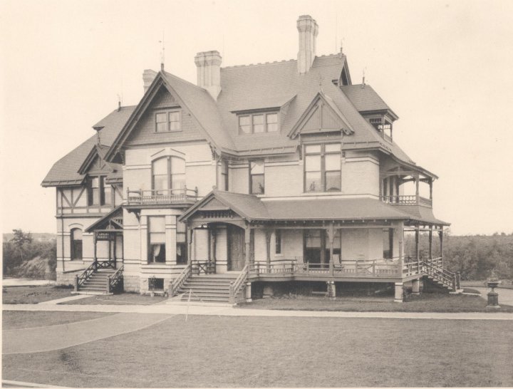 A historic photograph of a large Victorian house.