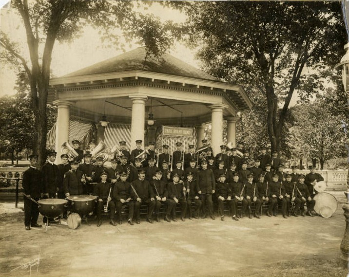 The Park Board Band in one of Milwaukee's parks, posed in front of an octagonal staging pavilion.