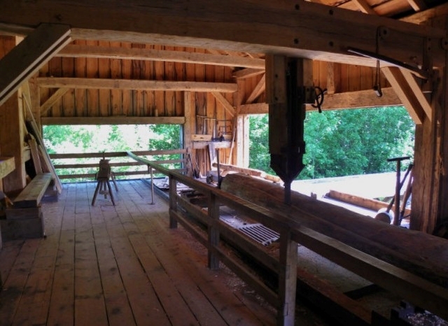 Photograph of the interior of the Herrling Sawmill showing the Muley saw, a type of single-blade mill that works in a up-down motion.