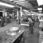 Interior photograph of the pattern shop. A man consults a drawing.