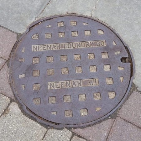 Read more about the article OBJECT HISTORY: Neenah Foundry Manhole Cover