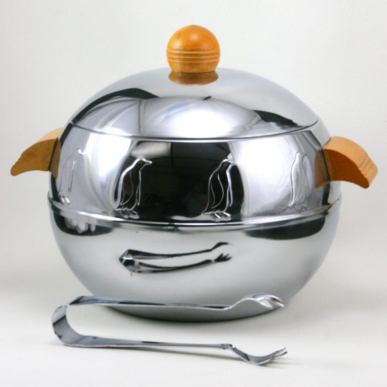 Image of the penguin server, a round aluminum object with wooden handles and repeating molded penguin reliefs around the top.