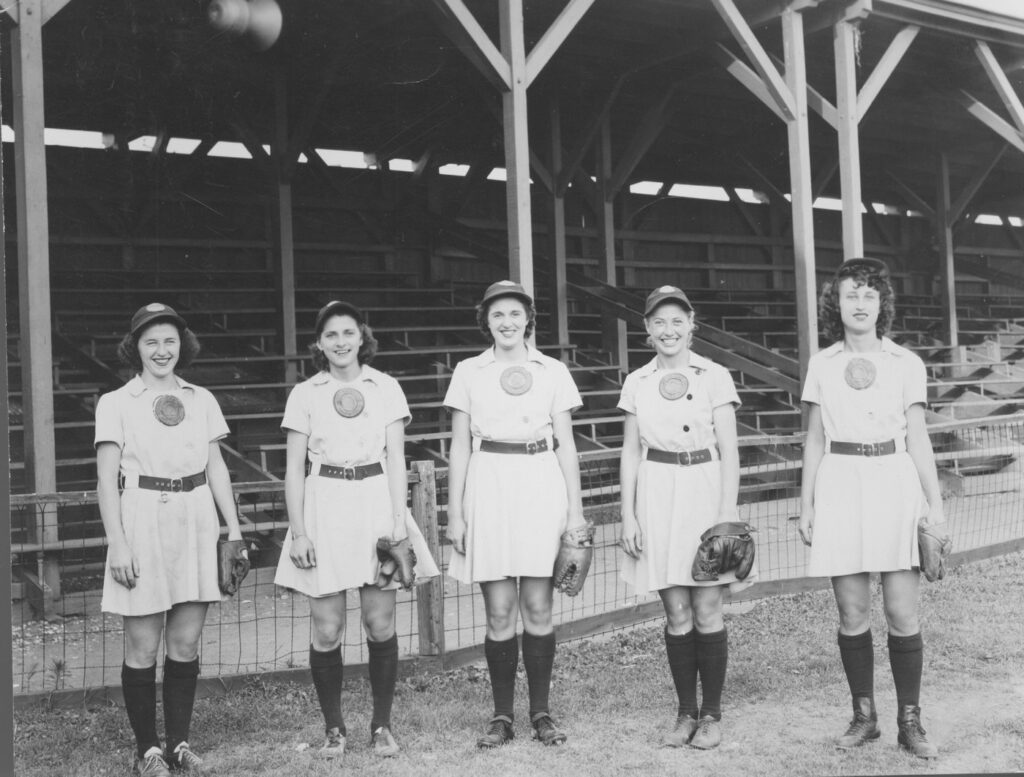 Five baseball players pose for the camera.
