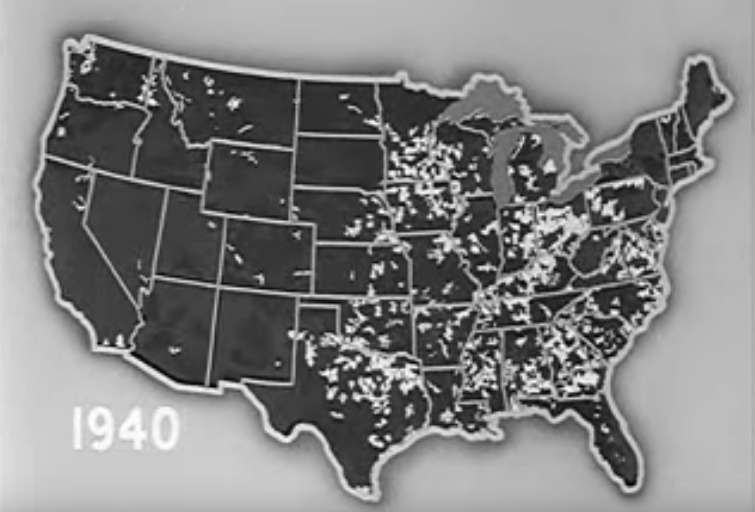 A film still of a map of the United States in 1940 showing the spread of rural electrification programs from east to west.