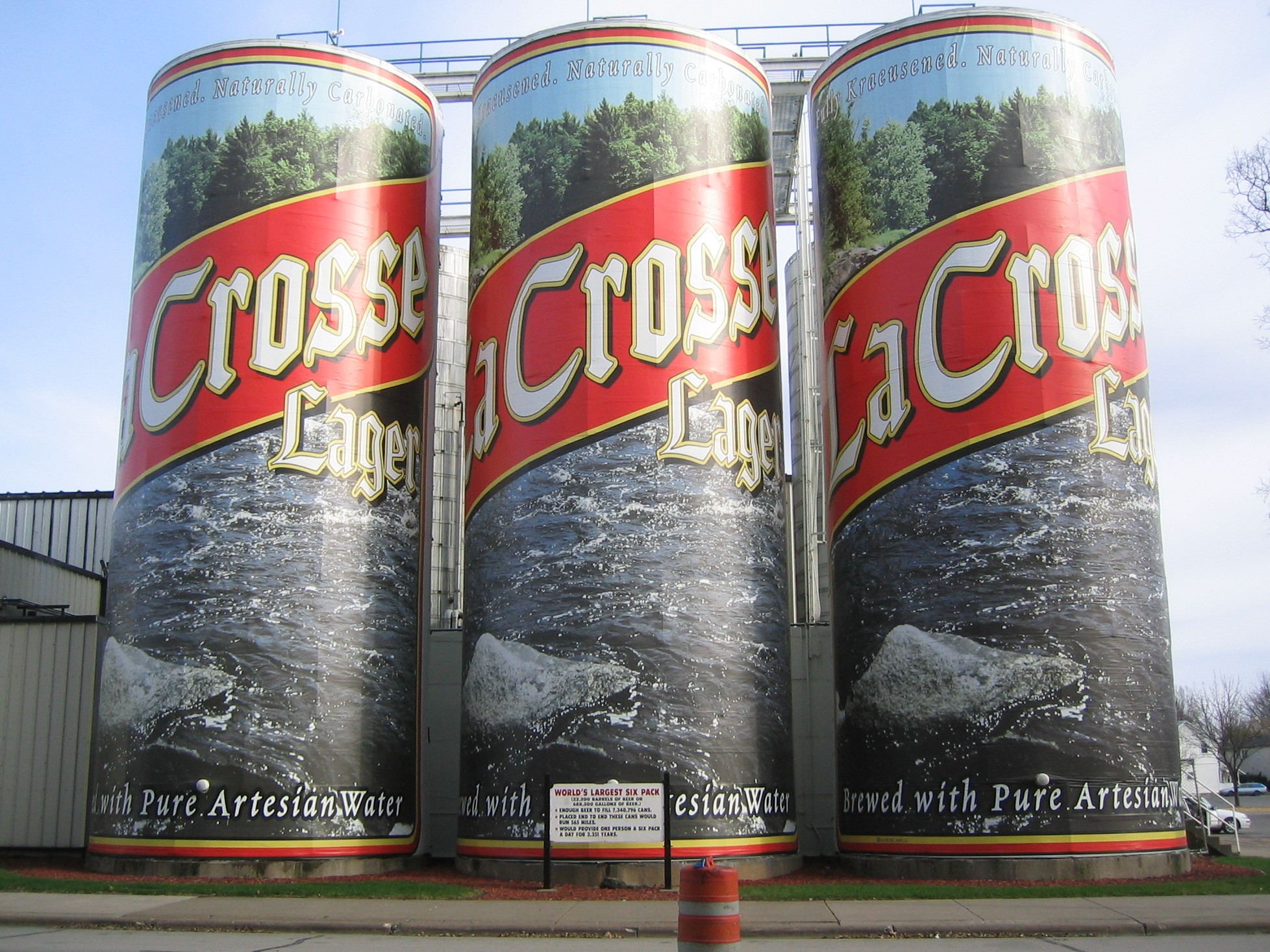 Six silos wrapped in plastic, designed to look like the LaCrosse Lager beer cans.