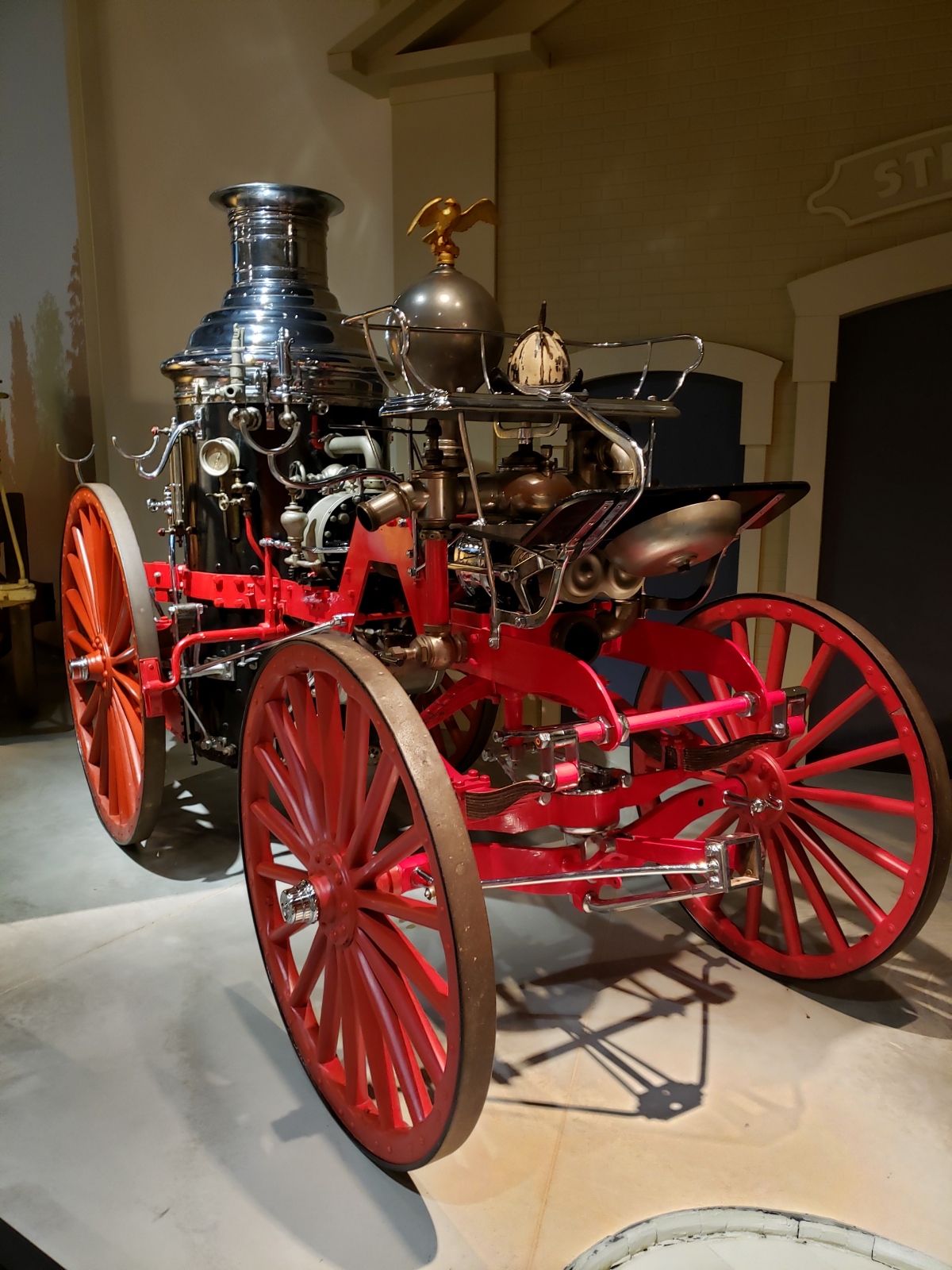A steam-powered fire engine. An open-frame wagon with a large steam engine that powers a pump to expel water from hoses.