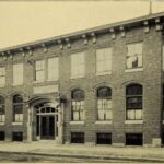 A two-story brick institutional building labeled the Abraham Lincoln House.