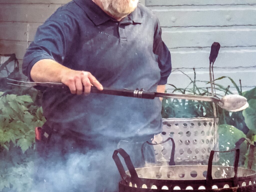 A master boiler holds a two-sided spork--a ladle lashed to the handle end of a long carving fork.