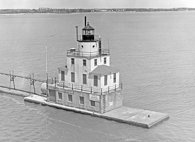 A black and white photograph of the Manitowoc Breakwater Lighthouse from Lake Michigan.