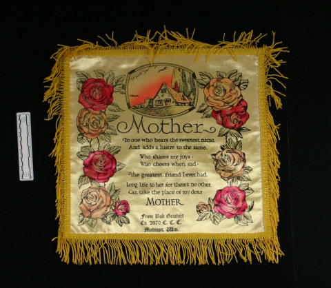 A printed pillowcase with roses, a cottage, and a poem titled, “Mother”