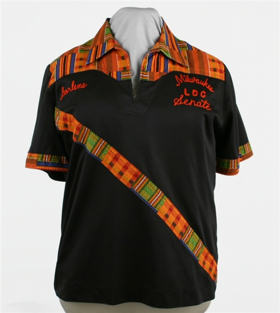Black Bowling shirt with a kente cloth patterned yoke and stripe.