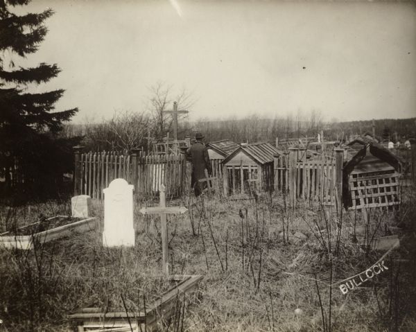 A black-and-white photograph of a Native American burial ground with above-ground tombs.