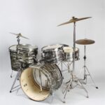 Well-used drum set with silver and black "Oyster Black Pearl" finish.