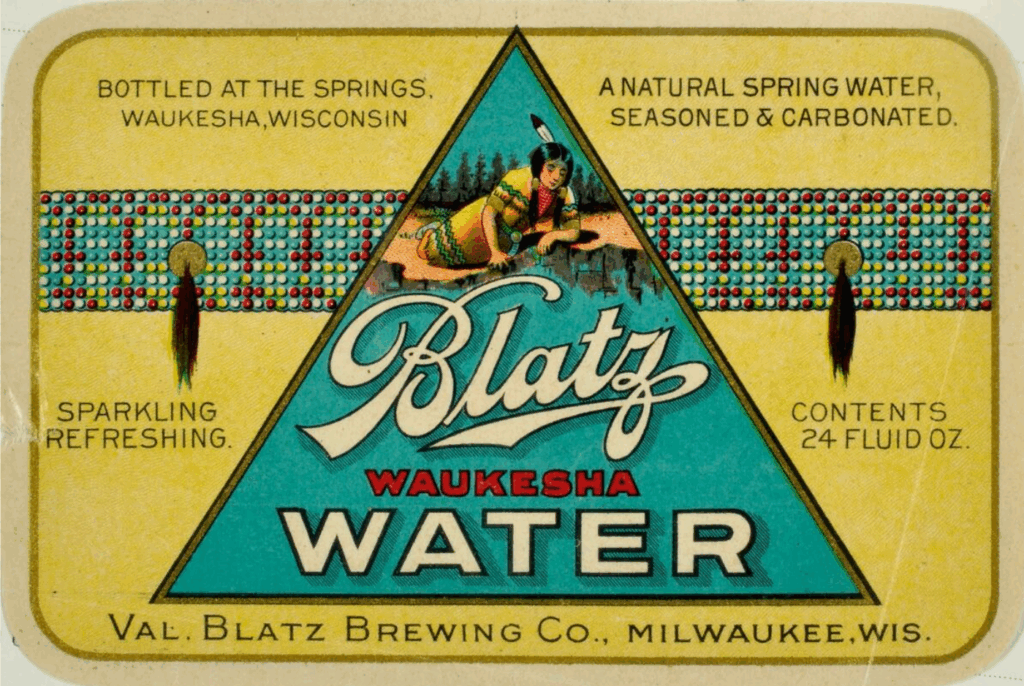 Bottle label that reads "Blatz Waukesha Water, Bottled at the Springs, Waukesha WI, A natural spring water, seasoned & carbonated, Sparkling refreshing. Val. Blatz Brewing Company." The label features an image of a Native American woman reclining on the shores of a lake.