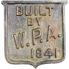 Metal badge with the text "Built by W.P.A. 1941" in relief.