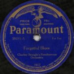 Paramount record label. A blue label with the image of an eagle atop a globe and the company name, Paramount.