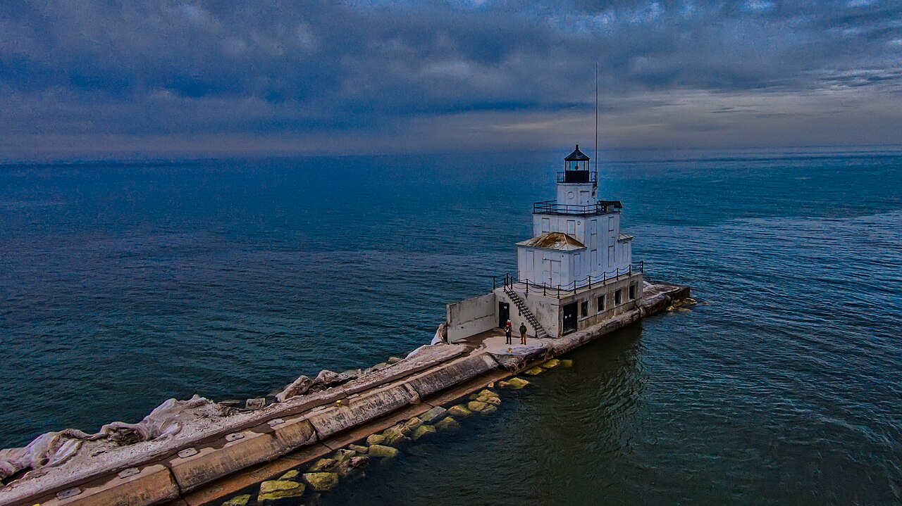 Photograph of the Manitowoc Breakwater Lighthouse from the harbor. The lighthouse is located on the end of the rocky breakwater and extends into Lake Michigan.