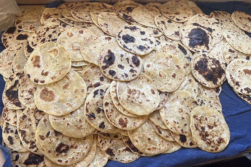 Tortillas piled on a table.