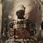 An ambrotype of America Jenkins in plaid dress and tignon headscarf.