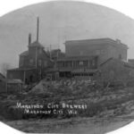A black and white photograph of the Marathon City Brewery.