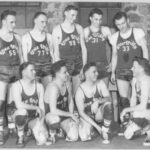 A posed group portrait of a basketball team.