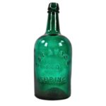 A dark green glass bottle, raised lettering reads “Saratoga Red Spring”